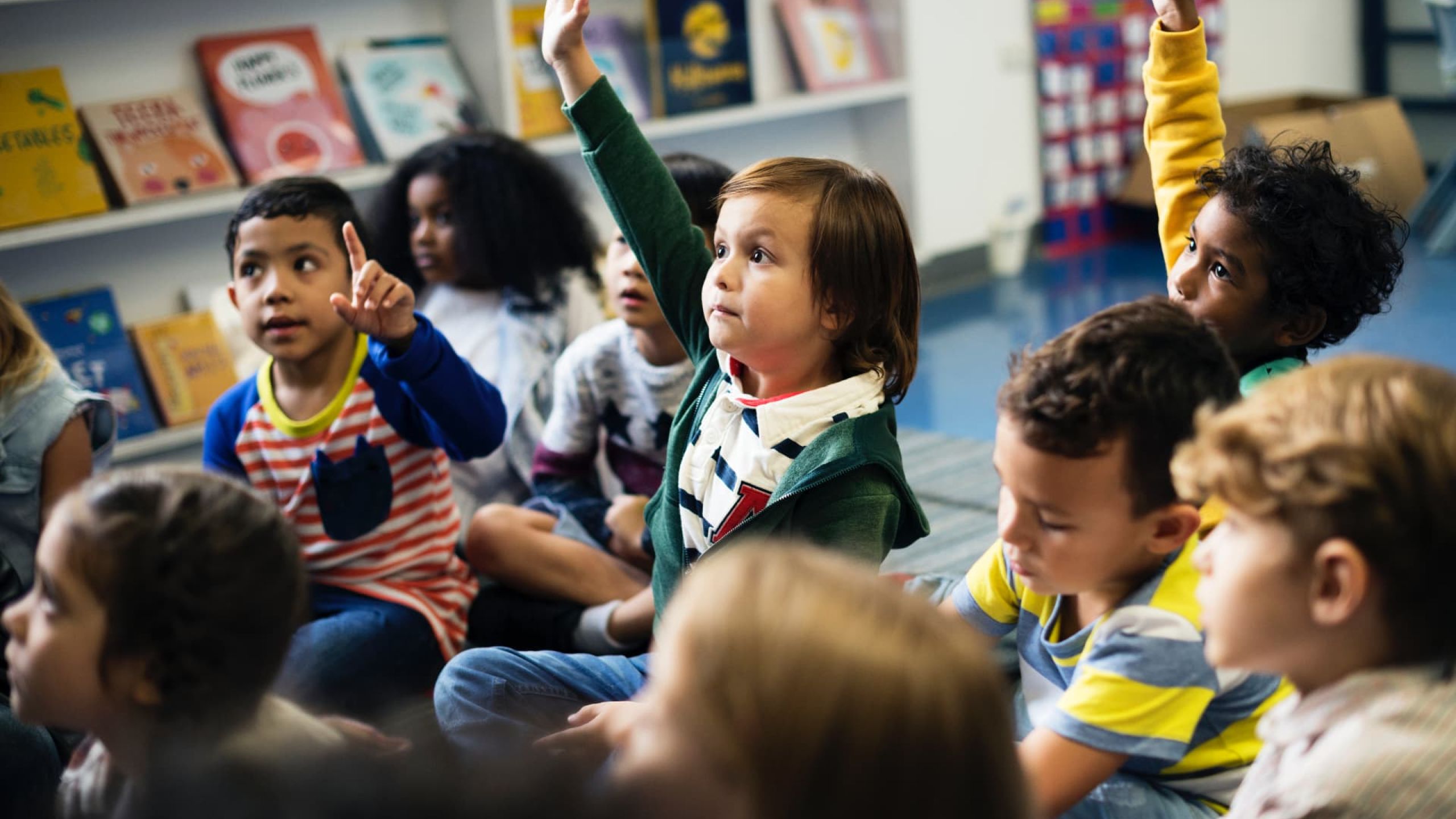niños y niñas de diferentes culturas participando activamente en clase, representando la diversidad cultural en el aula.